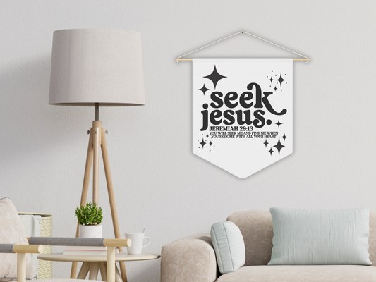 Decorative banner with 'seek Jesus' text hanging in a living room.