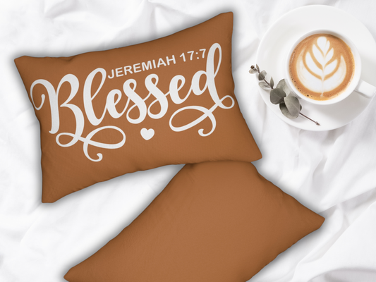Scripture pillow styled on white bedding with a latte in a white cup and eucalyptus sprig.