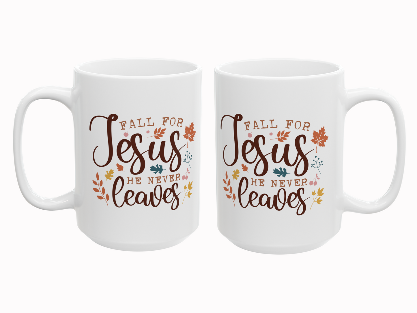 Two white mugs with 'Fall for Jesus he never leaves' text and leaf designs on a white background