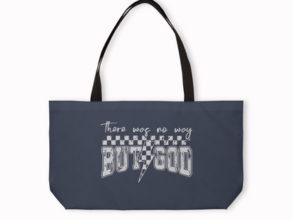 Navy blue tote bag with black straps featuring white text design that reads “There was no way BUT GOD” with checkerboard pattern and lightning bolt.