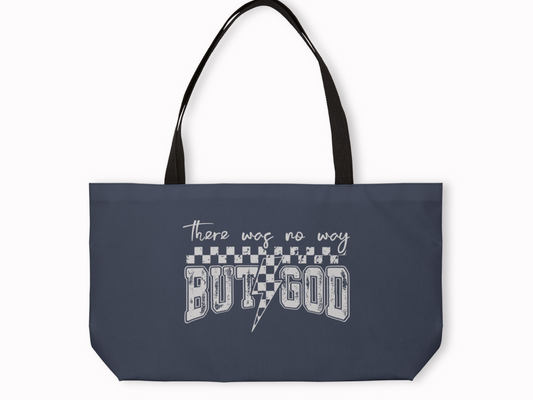 Navy blue tote bag with black straps featuring white text design that reads “There was no way BUT GOD” with checkerboard pattern and lightning bolt.