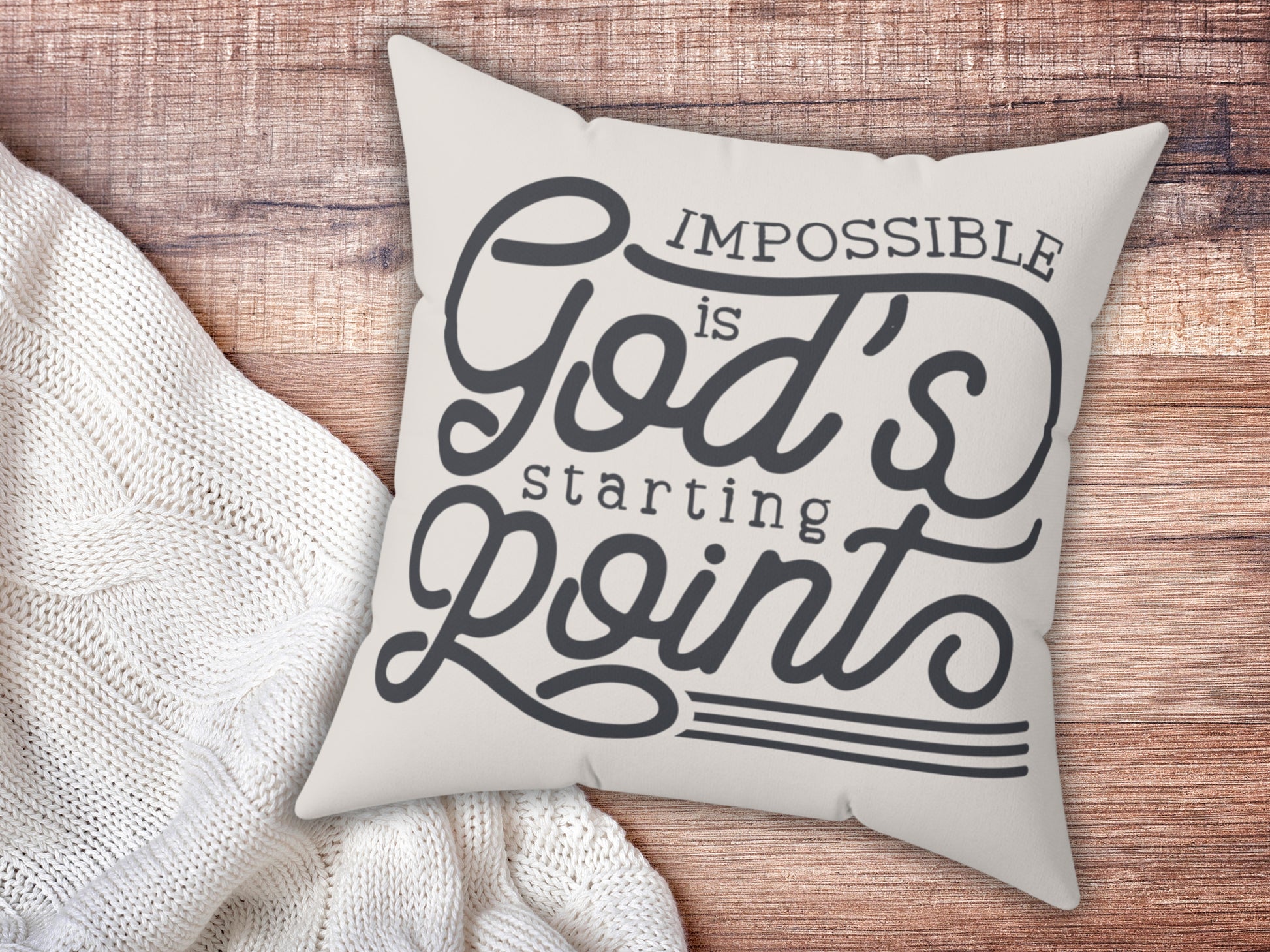 Decorative pillow with motivational quote on a wooden surface