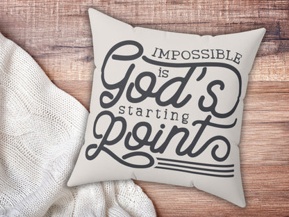 Decorative pillow with motivational quote on a wooden surface