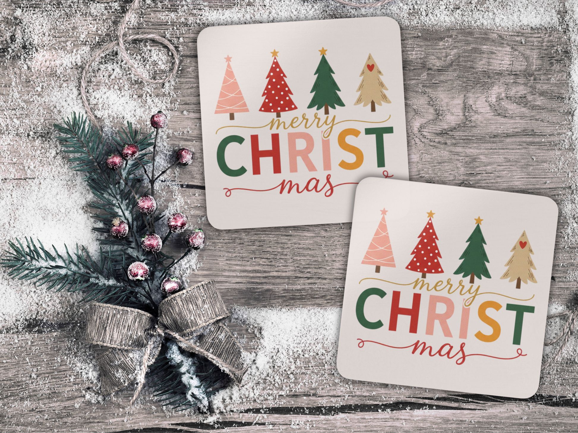 Two Christmas-themed coasters with decorative trees and text on a wooden surface.