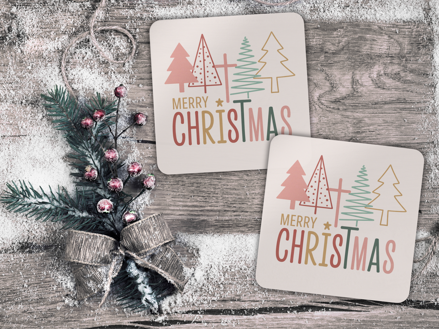 Two Christmas-themed coasters with trees and 'Merry Christmas' text on a wooden surface.