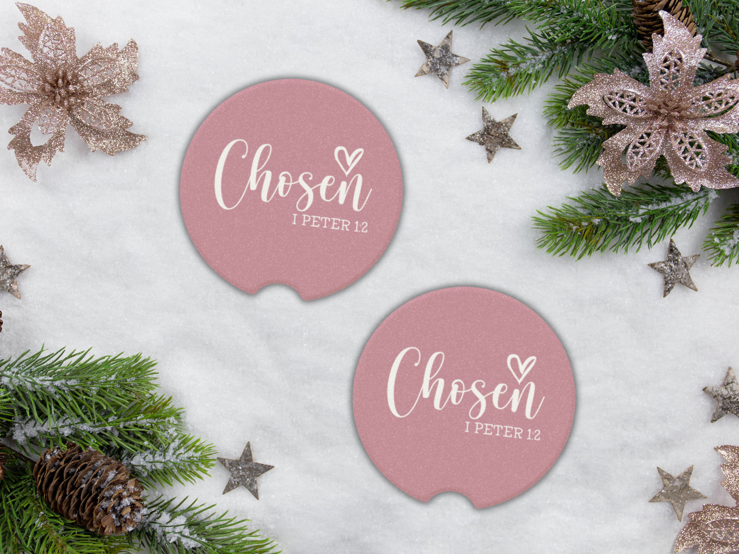 Pink car coasters with 'Chosen I Peter 1:2' text on a snowy background with Christmas decorations.