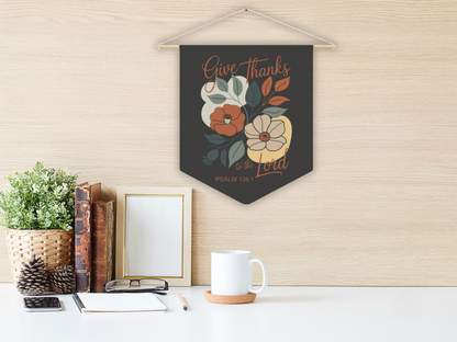 Decorative wall pennant with floral design and text on a wall above a desk.