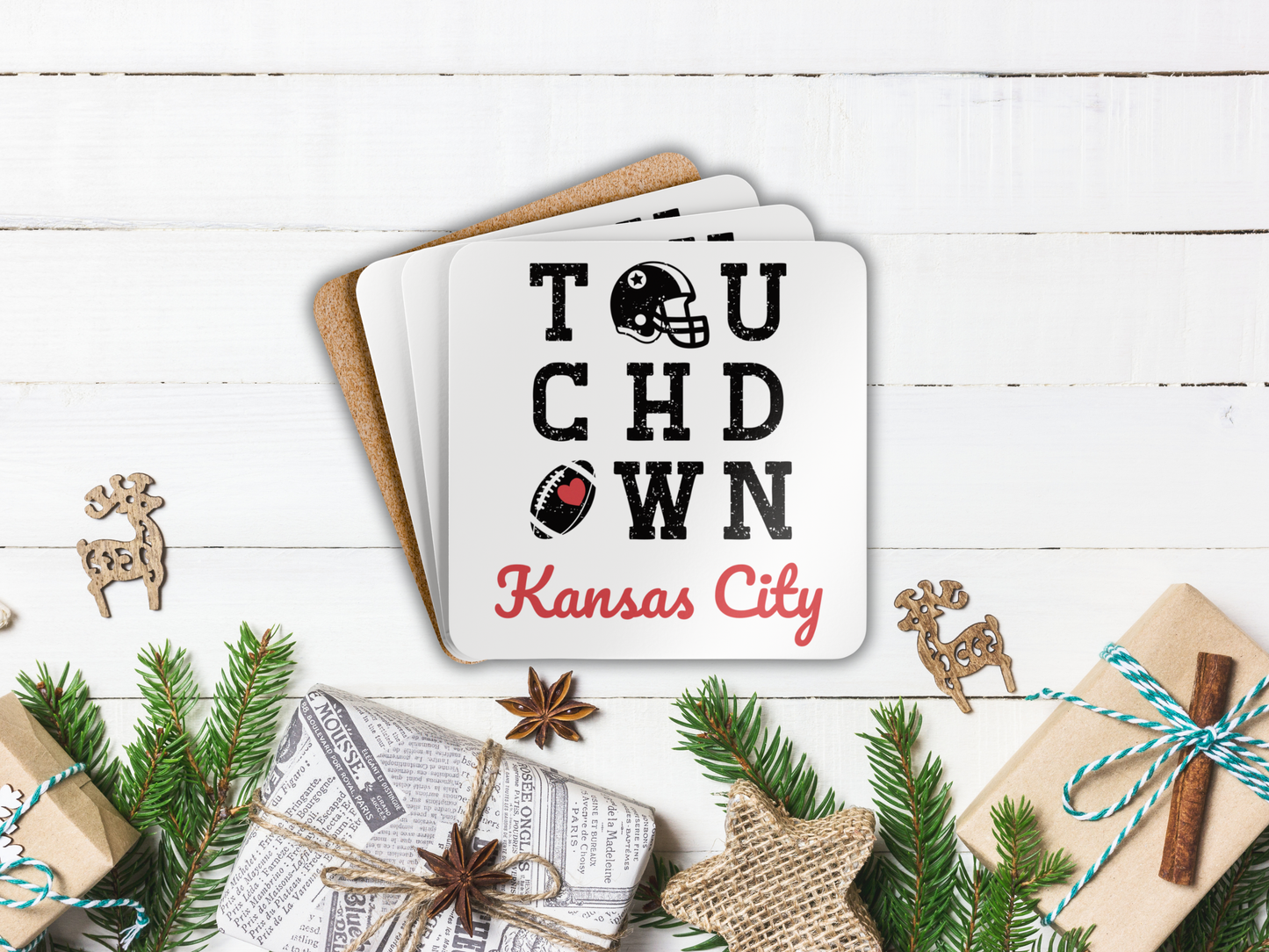 Stack of coasters with 'Touchdown Kansas City' design on a festive background with Christmas decorations.