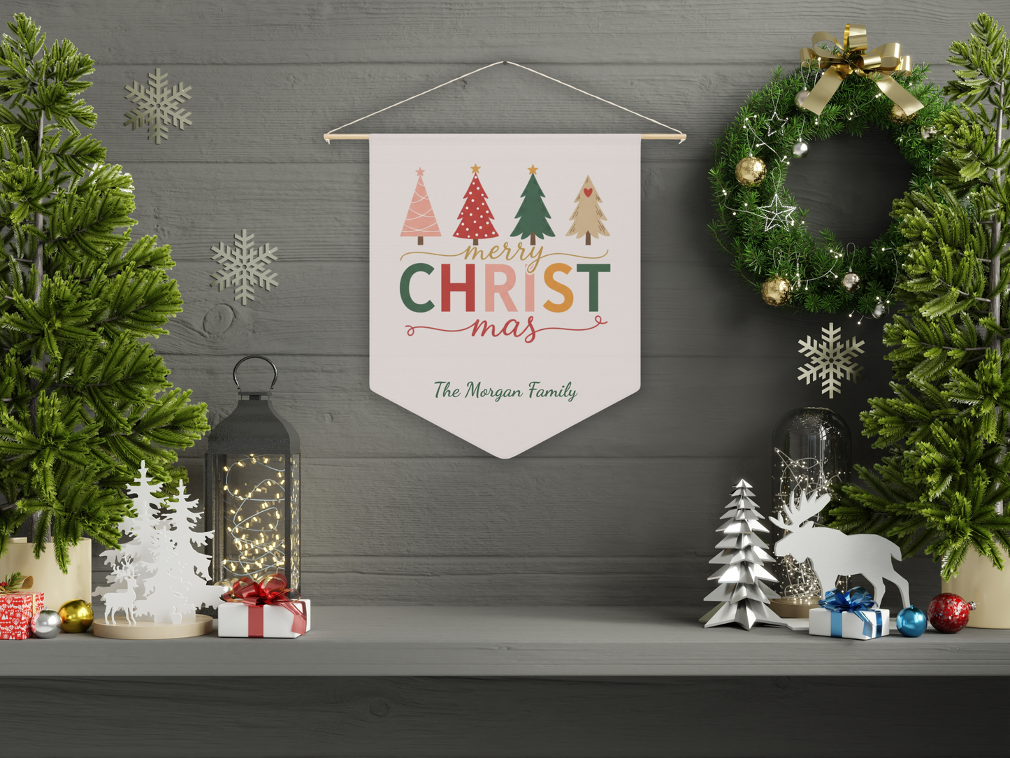 Decorative Christmas banner with trees and 'Merry Christmas' text on a wall with festive decorations.