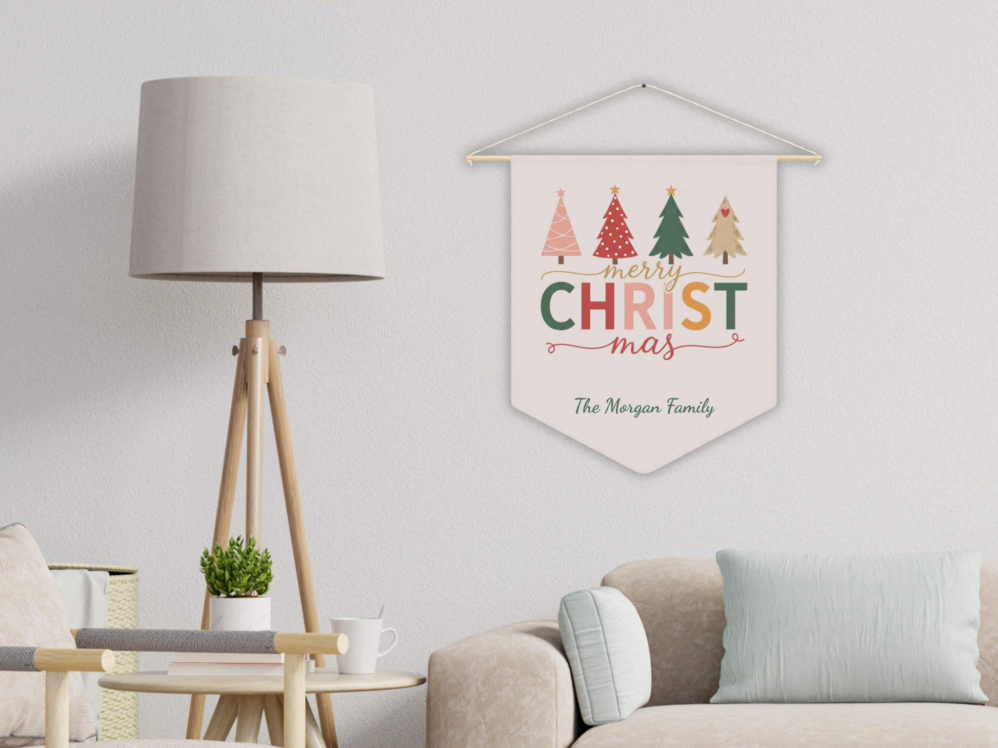 Decorative wall hanging with Christmas trees and 'Merry Christmas' text in a living room setting.