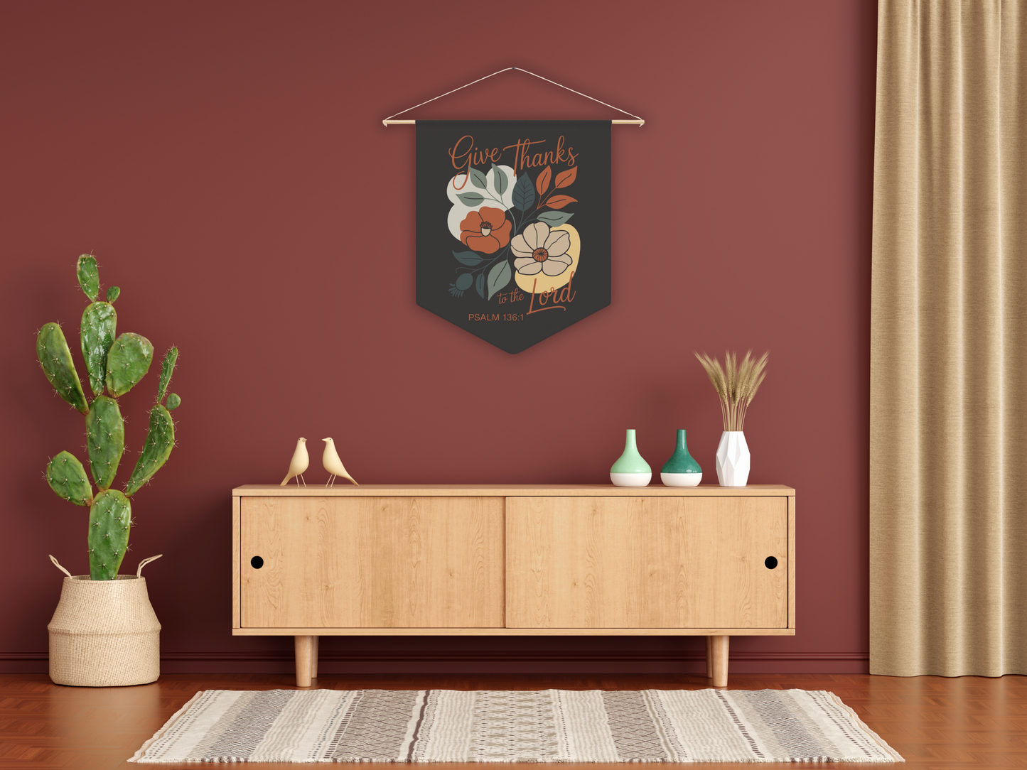 Decorative wall hanging with floral design above a wooden cabinet in a room with a plant and vases.
