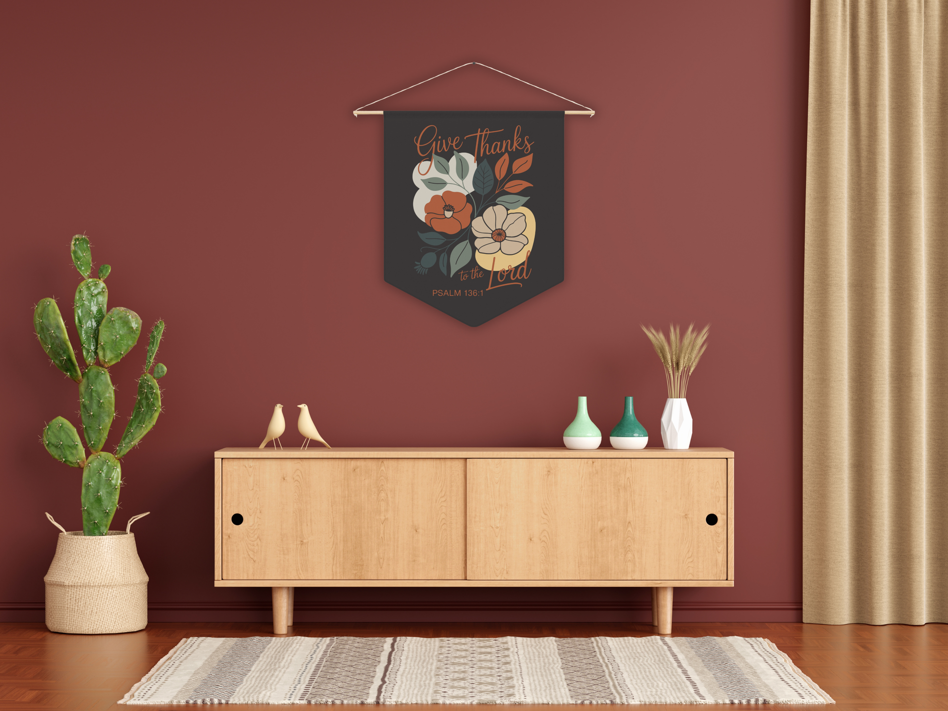 Decorative wall hanging with floral design above a wooden cabinet in a room with a plant and vases.