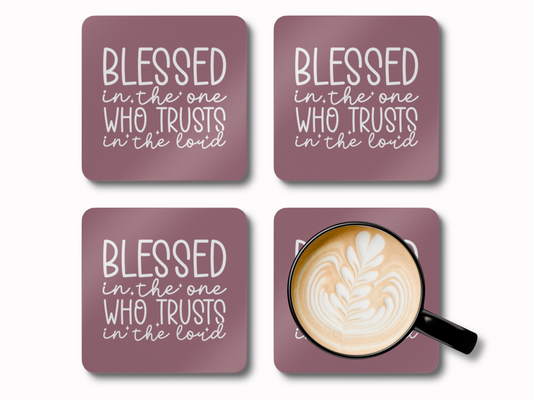 Set of four mauve scripture coasters, one holding a latte in a black cup.
