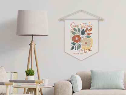 Decorative wall hanging with floral design and text in a living room setting.