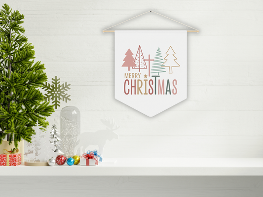 Decorative Christmas sign with trees and 'Merry Christmas' text on a white wall with festive decor.