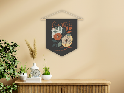 Decorative wall art with floral design and text on a beige wall above a wooden cabinet.