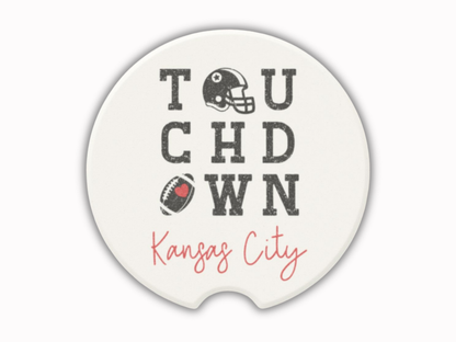 Ceramic coaster with 'Touchdown Kansas City' text and football graphics on a white background