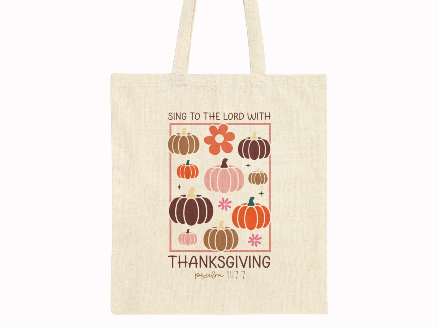 Beige cotton canvas tote bag with pumpkins, florals, and scripture “Sing to the Lord with Thanksgiving – Psalm 147:7” on plain background.