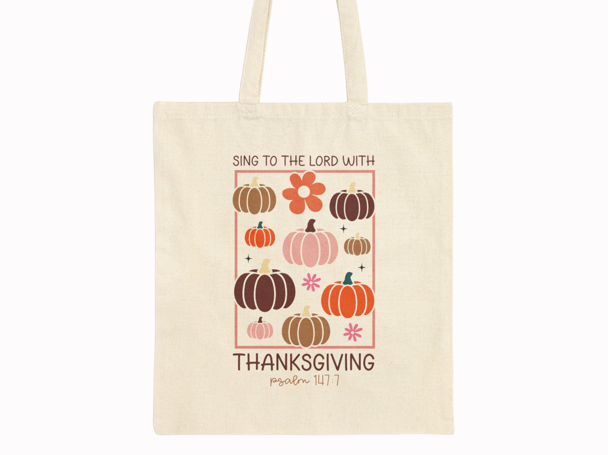 Beige cotton canvas tote bag with pumpkins, florals, and scripture “Sing to the Lord with Thanksgiving – Psalm 147:7” on plain background.