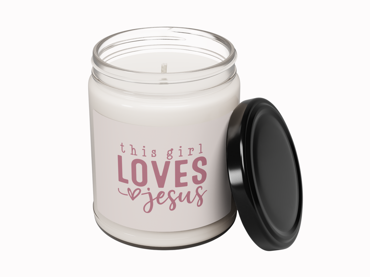 Candle jar with 'this girl loves Jesus' text on a white background