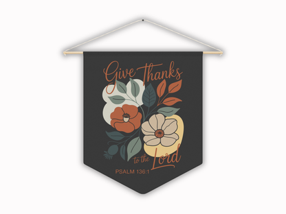Decorative banner with floral design and text 'Give Thanks to the Lord' on a dark background.