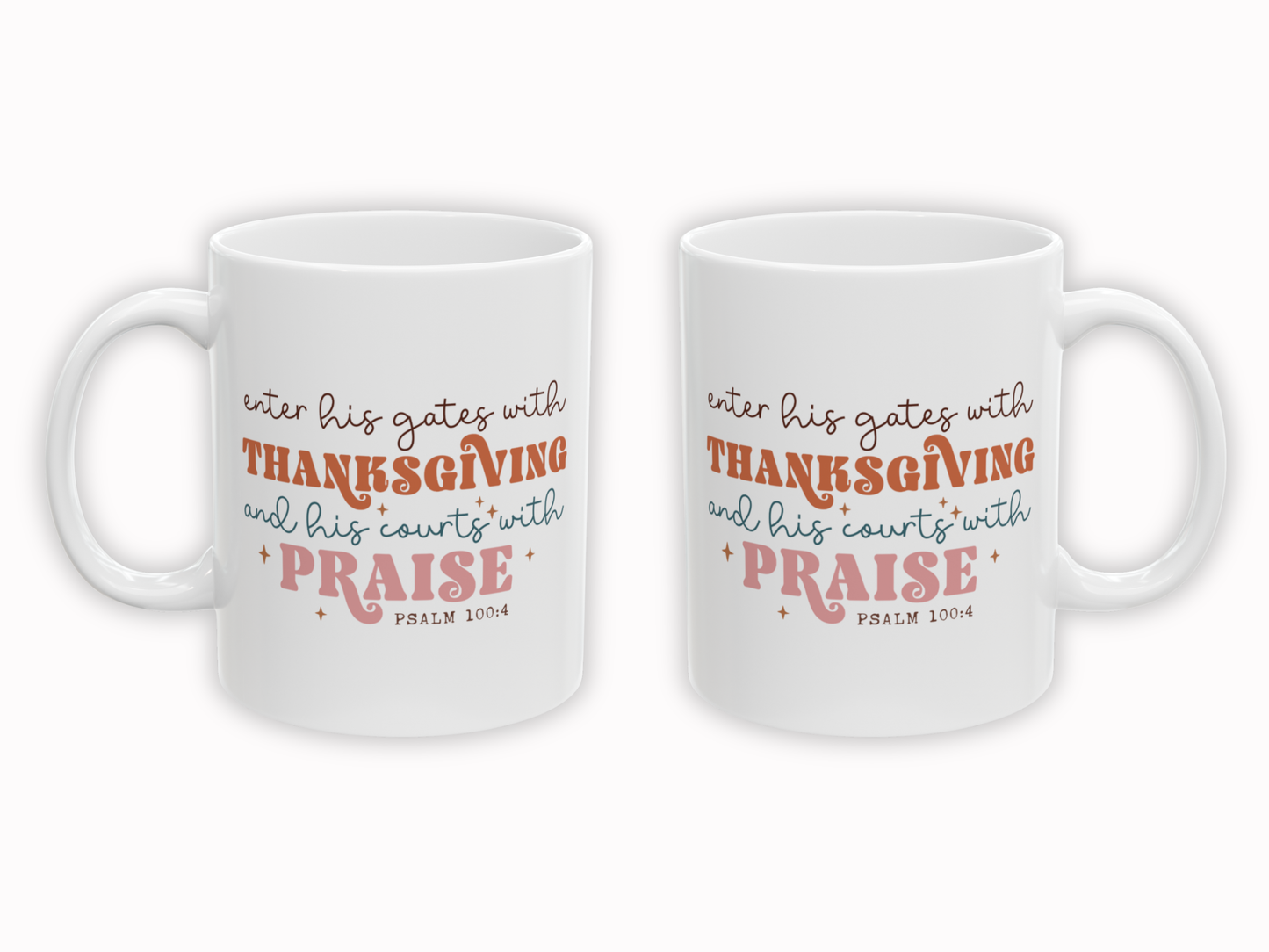 Two white mugs with orange and pink text on a white background