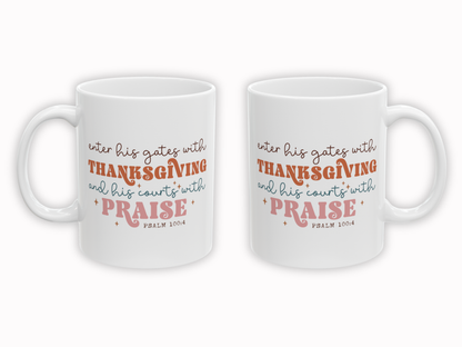 Two white mugs with orange and pink text on a white background