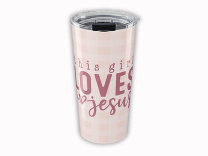 Tumbler with 'This girl loves Jesus' text on a light pink background
