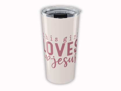 Tumbler with 'This girl loves Jesus' text on a white background