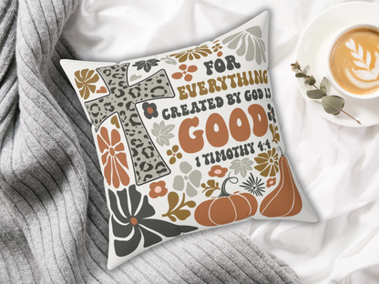 Christian fall pillow with leopard cross and Bible verse, styled on white bedding with gray knit blanket and latte in cup.