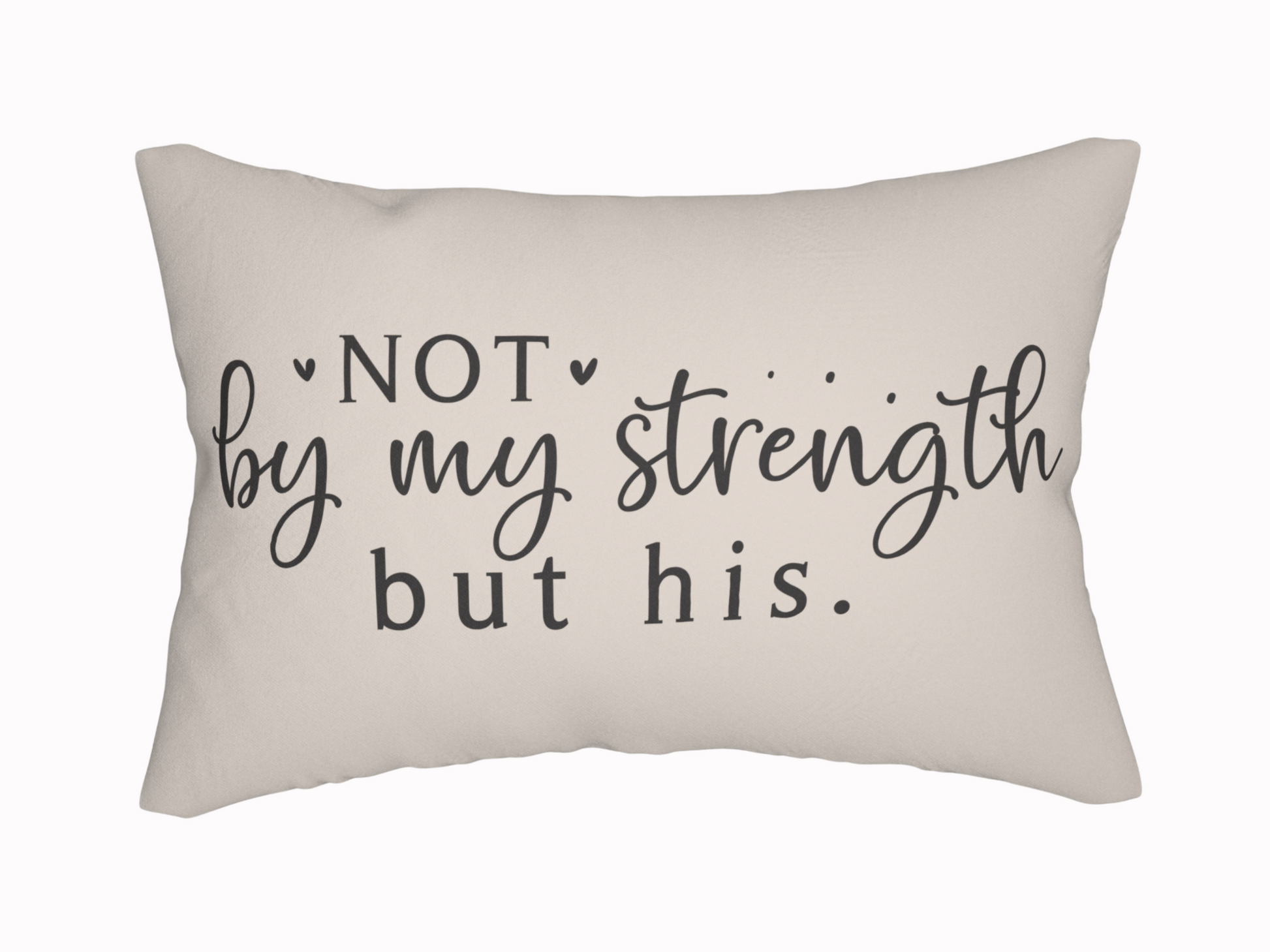 A beige pillow with the phrase "Not by my strength but his" in elegant black script and print, conveying a tone of faith and inspiration.