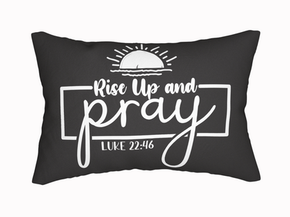Black pillow featuring the phrase "Rise Up and Pray" in white, stylized text, with a rising sun graphic above and "Luke 22:46" below, conveying inspiration.