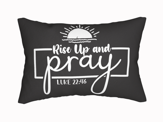 Black pillow featuring the phrase "Rise Up and Pray" in white, stylized text, with a rising sun graphic above and "Luke 22:46" below, conveying inspiration.