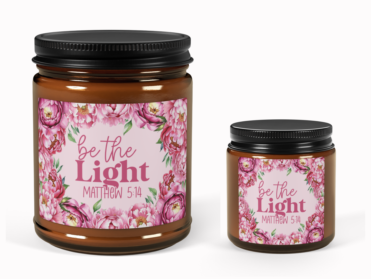 Two brown jars with black lids featuring floral labels. The labels display pink peonies and the text "be the Light, Matthew 5:14" in elegant fonts.