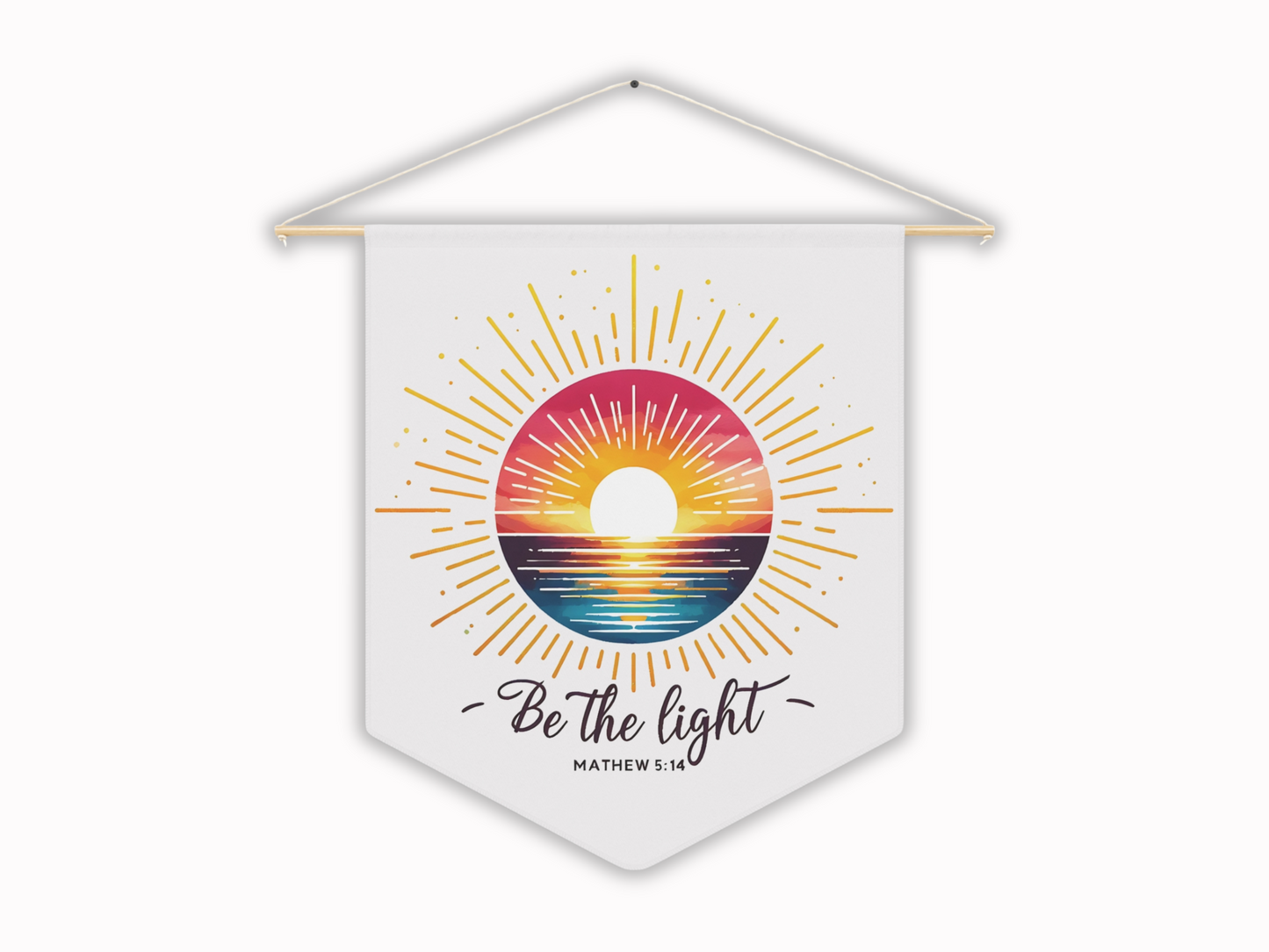 Hanging wall decor features a vibrant sunset over the ocean framed by sun rays on a white banner with the words "Be the light" and "Matthew 5:14." Energetic and inspirational.