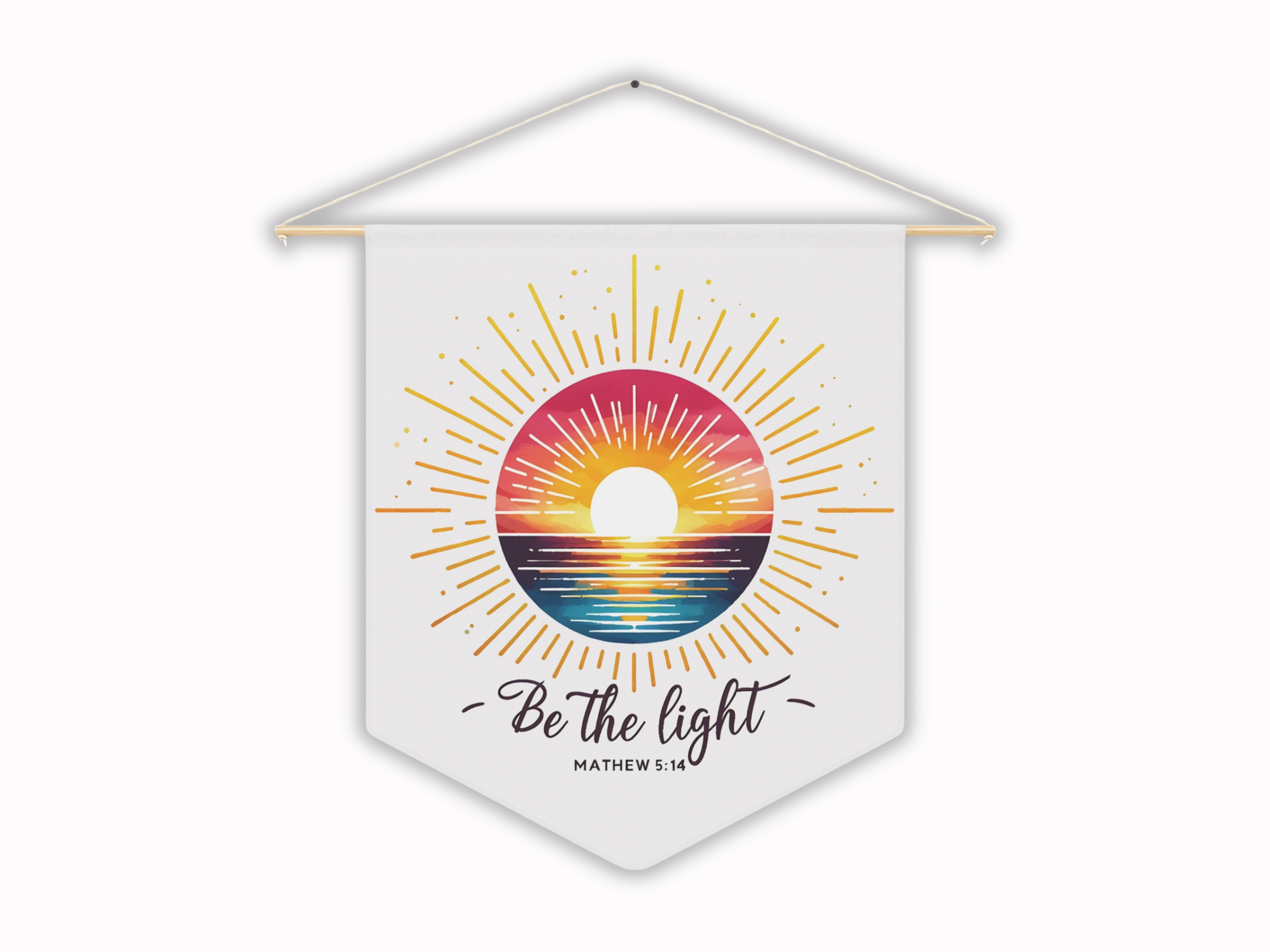Hanging wall decor features a vibrant sunset over the ocean framed by sun rays on a white banner with the words "Be the light" and "Matthew 5:14." Energetic and inspirational.