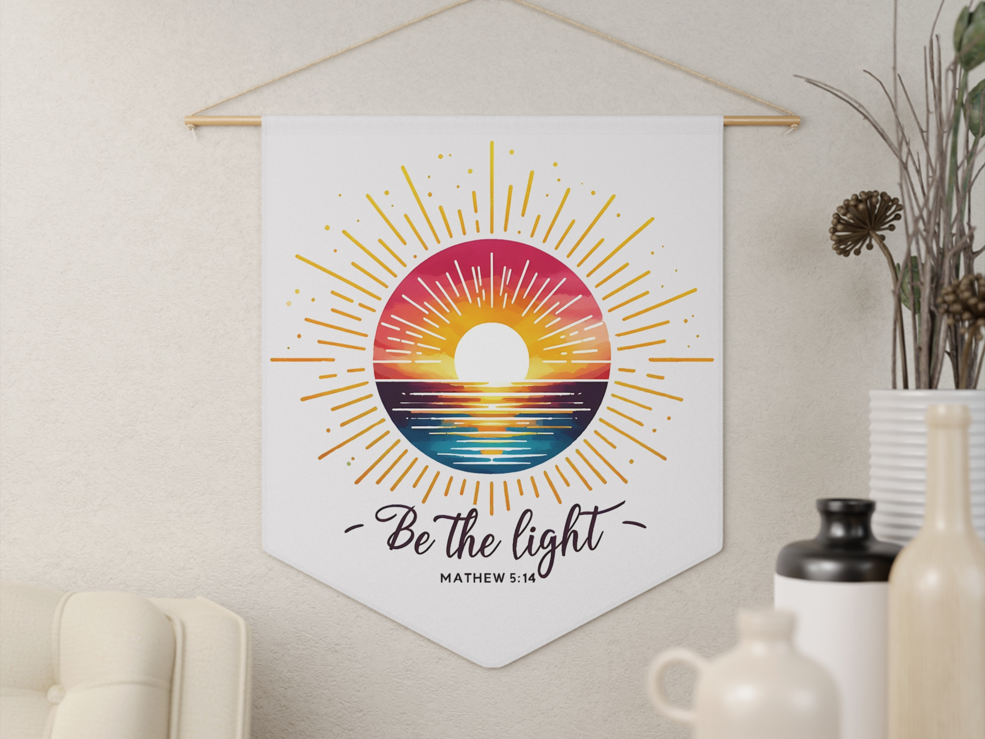 A wall hanging features a colorful sunrise over the ocean with radiant beams. Below, the words "Be the light" and "Matthew 5:14" offer inspiration.