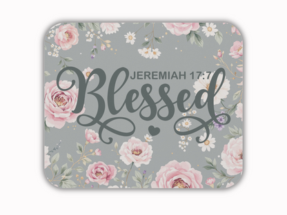 Floral-themed image with "Blessed" in elegant script, featuring pale pink roses and white flowers on a gray background. Reference: Jeremiah 17:7.