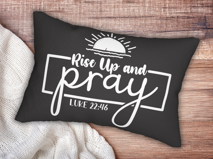 A black pillow on a wooden surface reads "Rise Up and Pray, Luke 22:46" in white script. A sunrise illustration adds a hopeful tone.