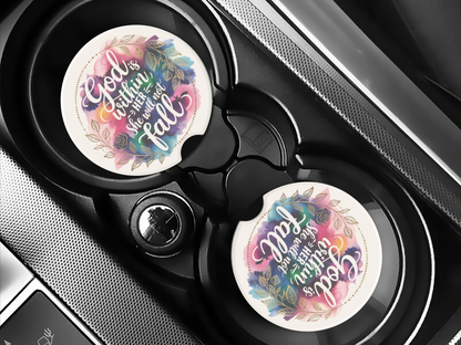 Car cup holders with colorful coasters featuring the quote "God is within her, she will not fall." The design includes floral patterns with a calm, uplifting tone.