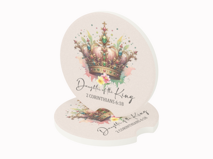 Elegant round coasters feature a watercolor crown with colorful splashes and text "Daughter of the King, 2 Corinthians 6:18." Regal and inspirational.