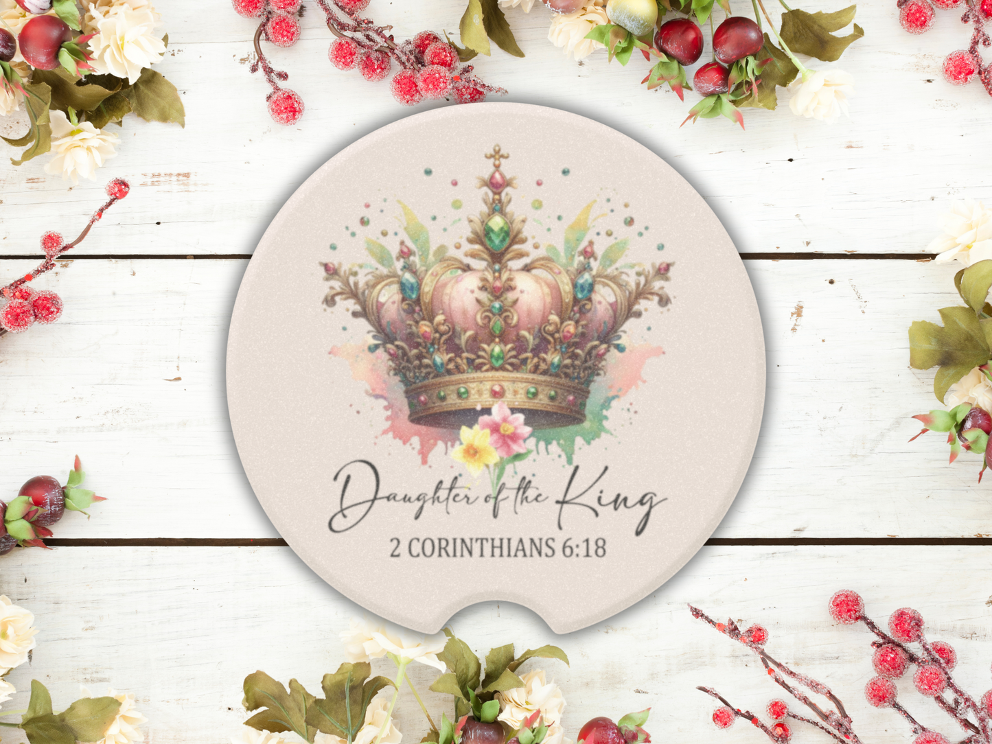 A round card features an ornate, colorful crown with watercolor splashes. Below, script text reads, "Daughter of the King, 2 Corinthians 6:18." Surrounded by berries and flowers, the scene is elegant and uplifting.