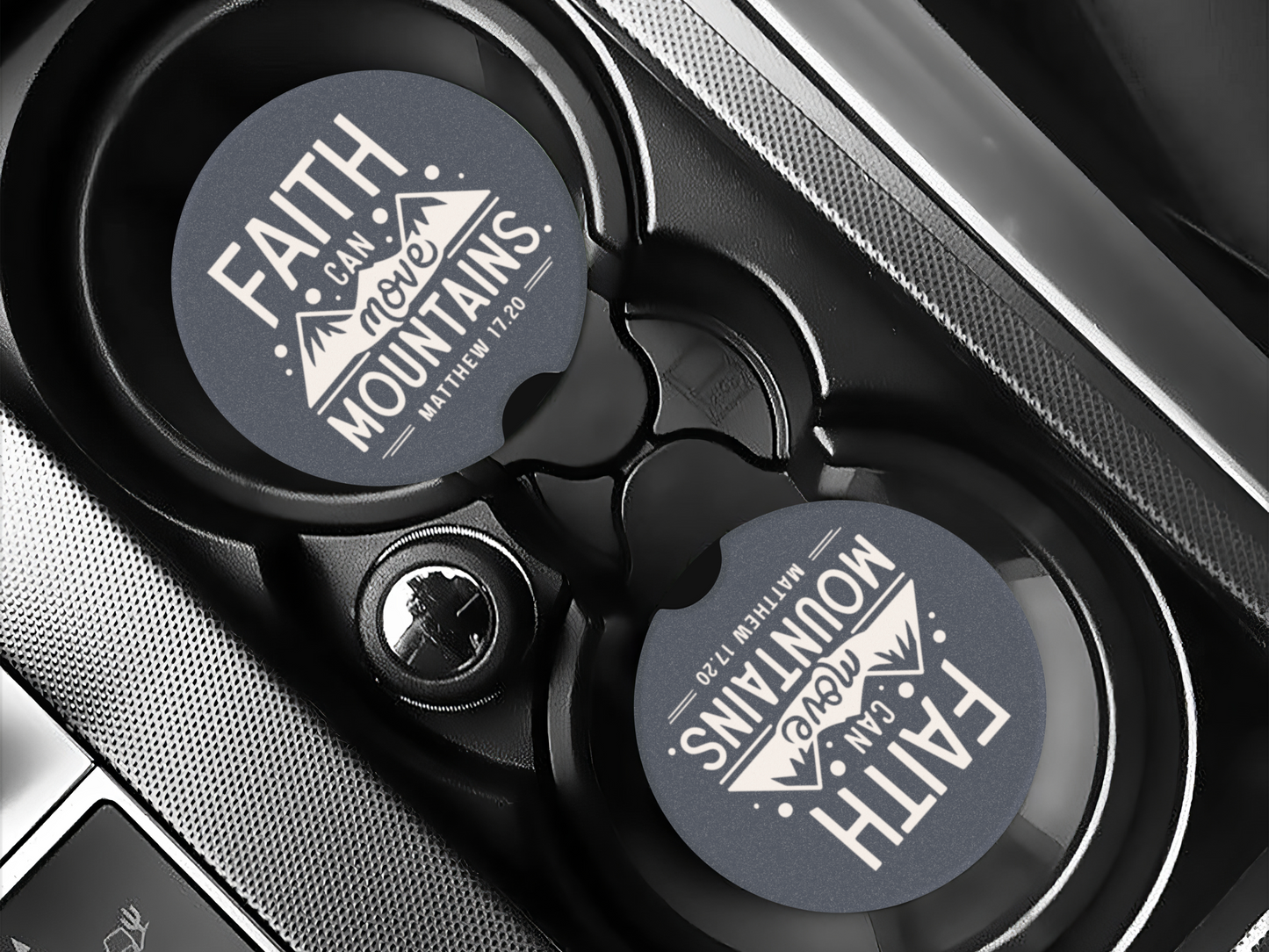 Car cup holder with round coasters displaying "Faith can move mountains, Matthew 17:20" in white text on a dark background, emphasizing hope.
