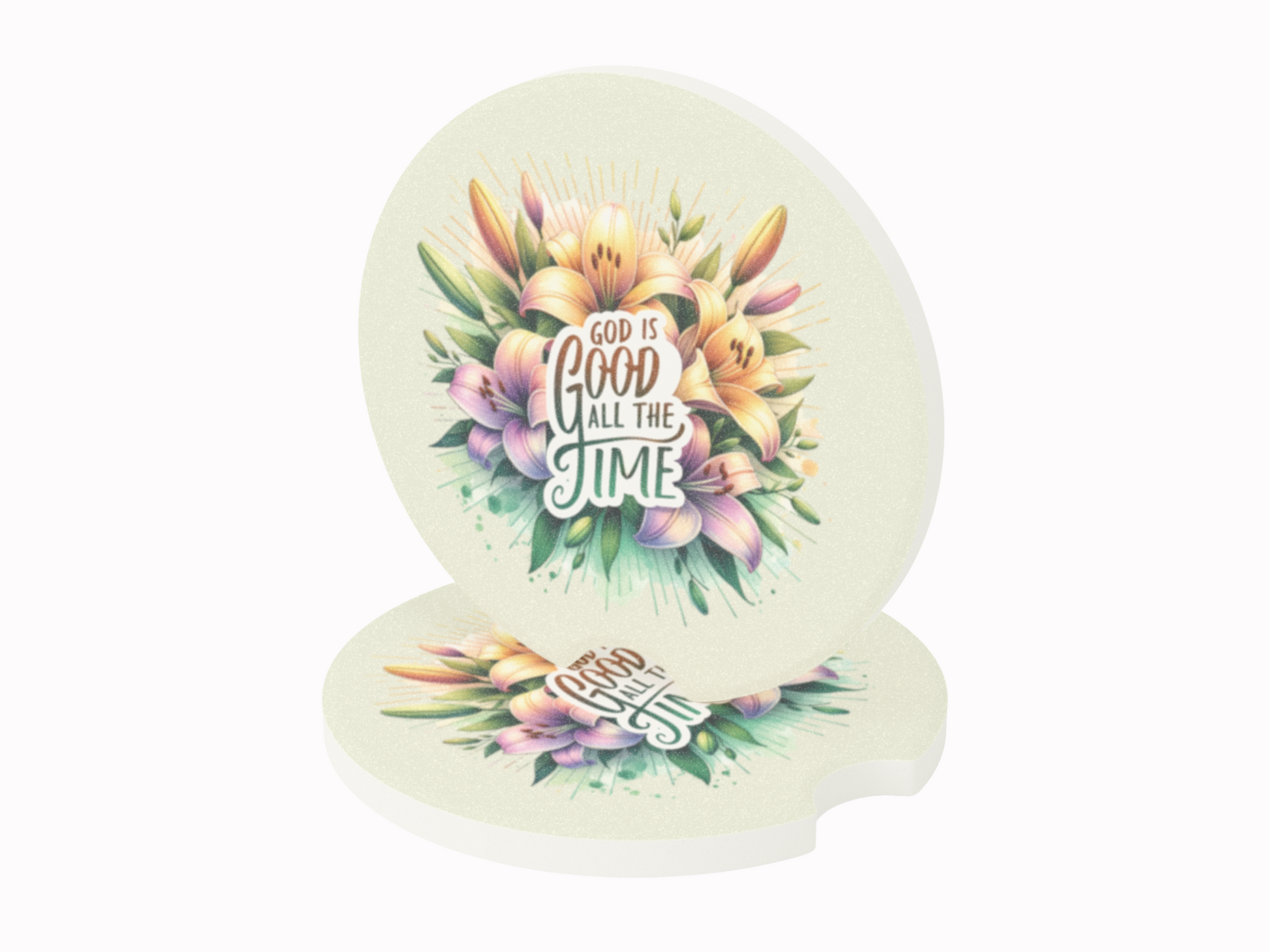 Round coasters featuring vibrant lilies and leaves with the text "God is good all the time" in bold, artistic fonts. Uplifting and colorful.