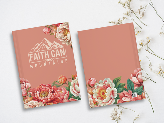 Two pink notebooks with floral designs on the cover. One features "Faith Can Move Mountains" text with illustrated mountains. Delicate white flowers surround them.