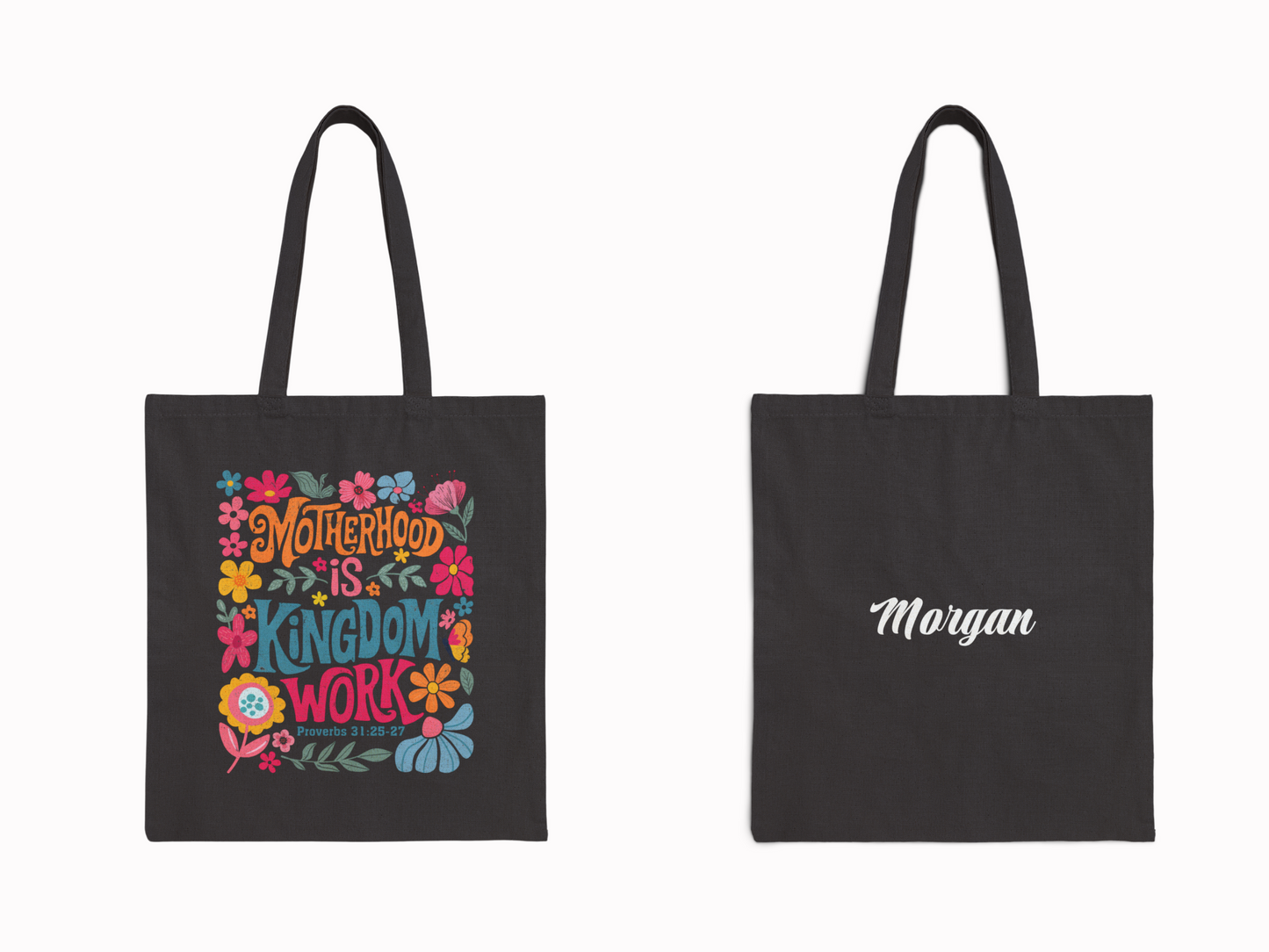 Black tote bag featuring vibrant floral designs with the text "Motherhood is Kingdom Work," and Proverbs 31:25-27. Other side reads "Morgan."