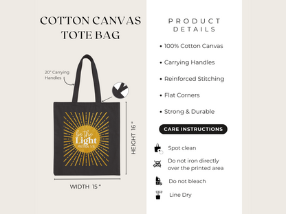 Cotton canvas tote bag with "Be the Light" design, 16x15 inches, 20-inch handles. Features include reinforced stitching. Care: spot clean, line dry.