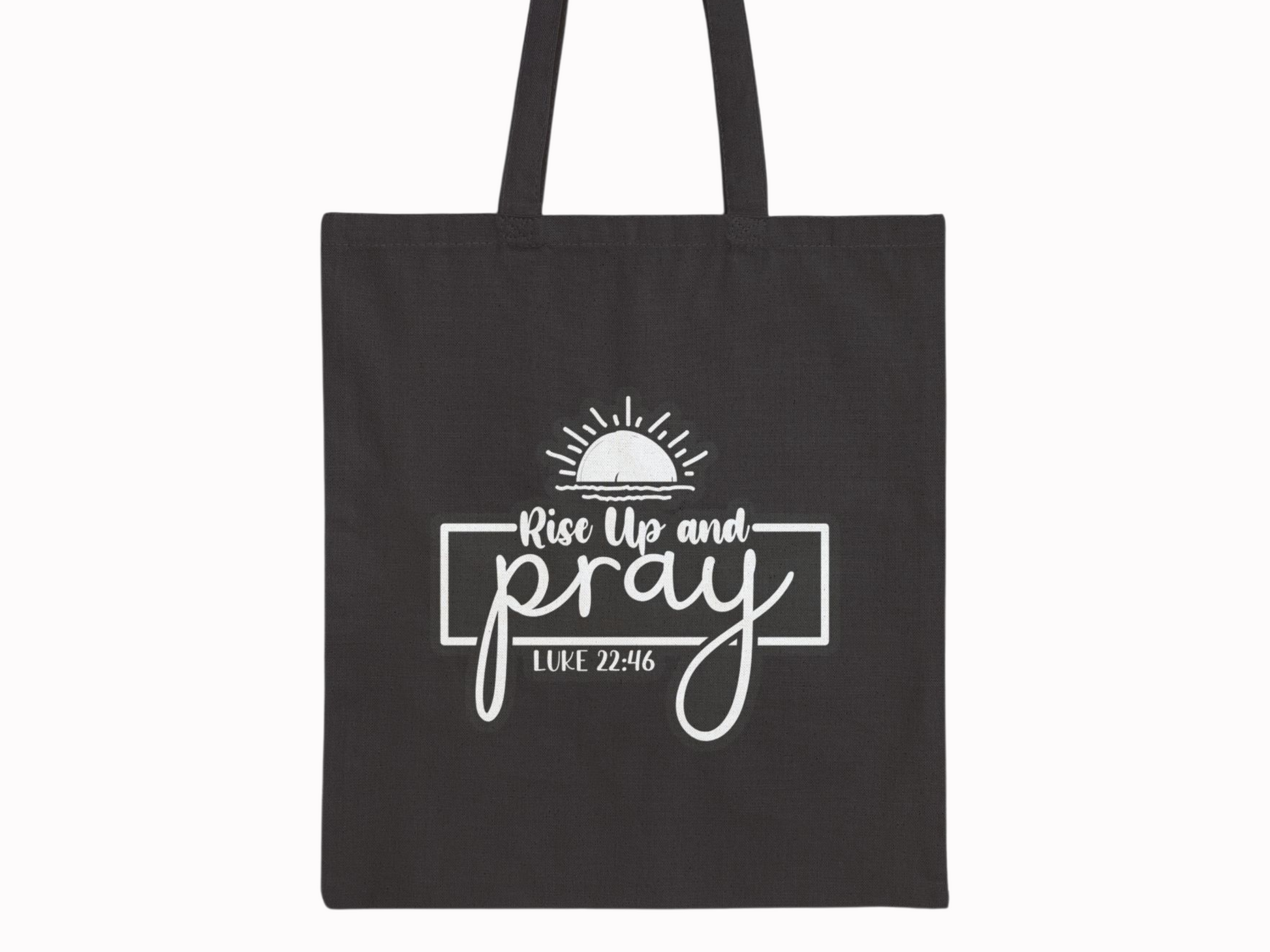 Black tote bag featuring the text "Rise Up and Pray" with a sunrise graphic above, and "Luke 22:46" below in white. Simple and inspirational design.
