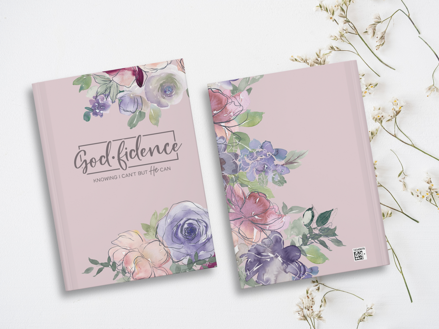 Two soft purple books with watercolor floral designs are on a white background. The front one reads "Godfidence: Knowing I can't but He can" in elegant script.