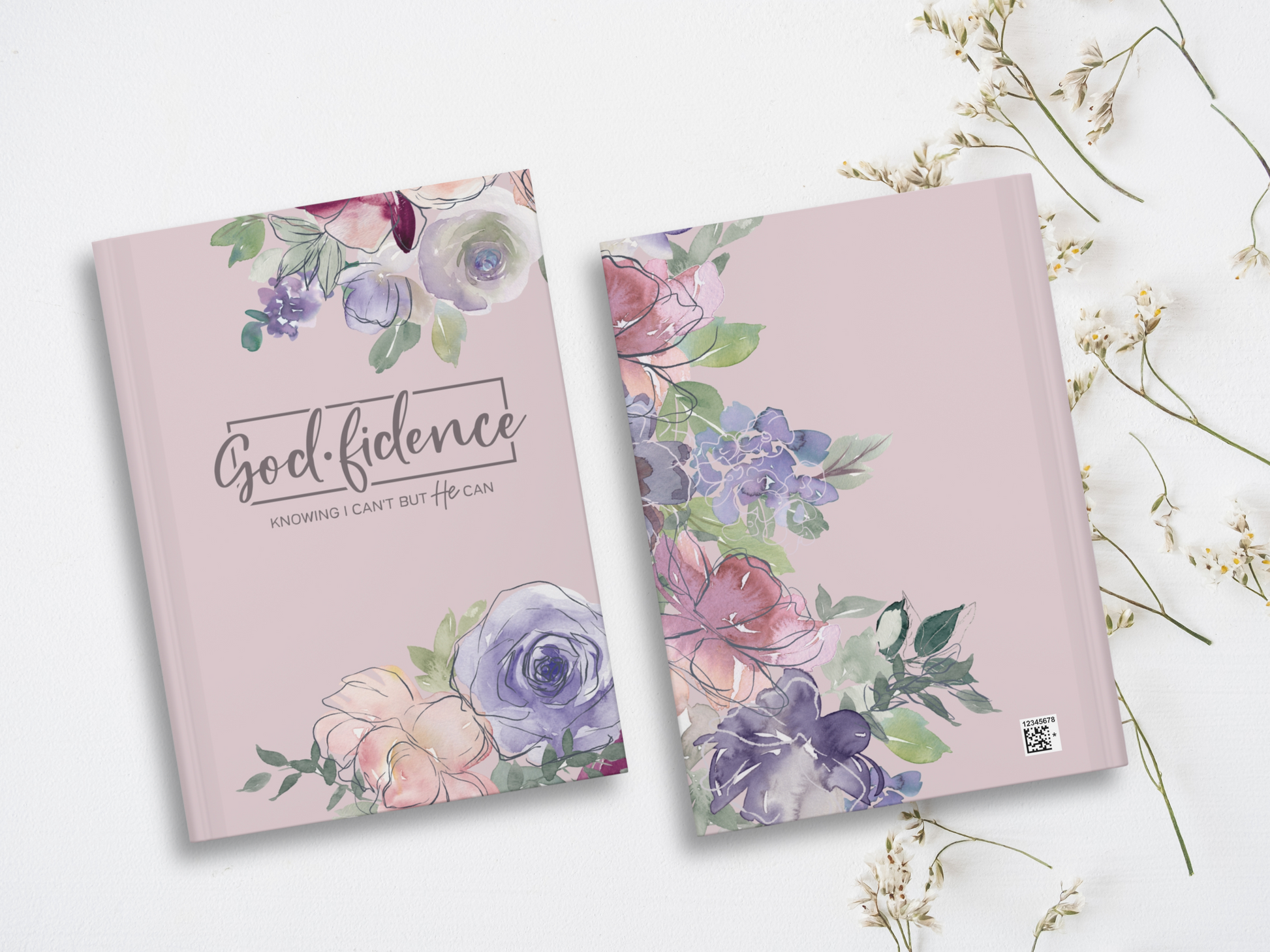 Two soft purple books with watercolor floral designs are on a white background. The front one reads "Godfidence: Knowing I can't but He can" in elegant script.